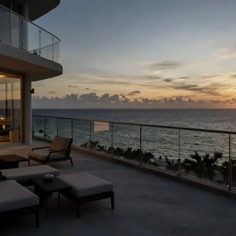 Balcony overlooking the ocean at sunset